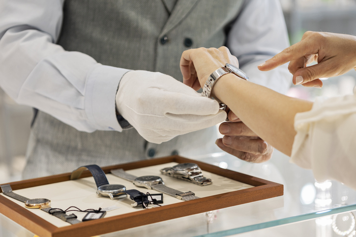 Young woman trying a wristwatch in jewelry store